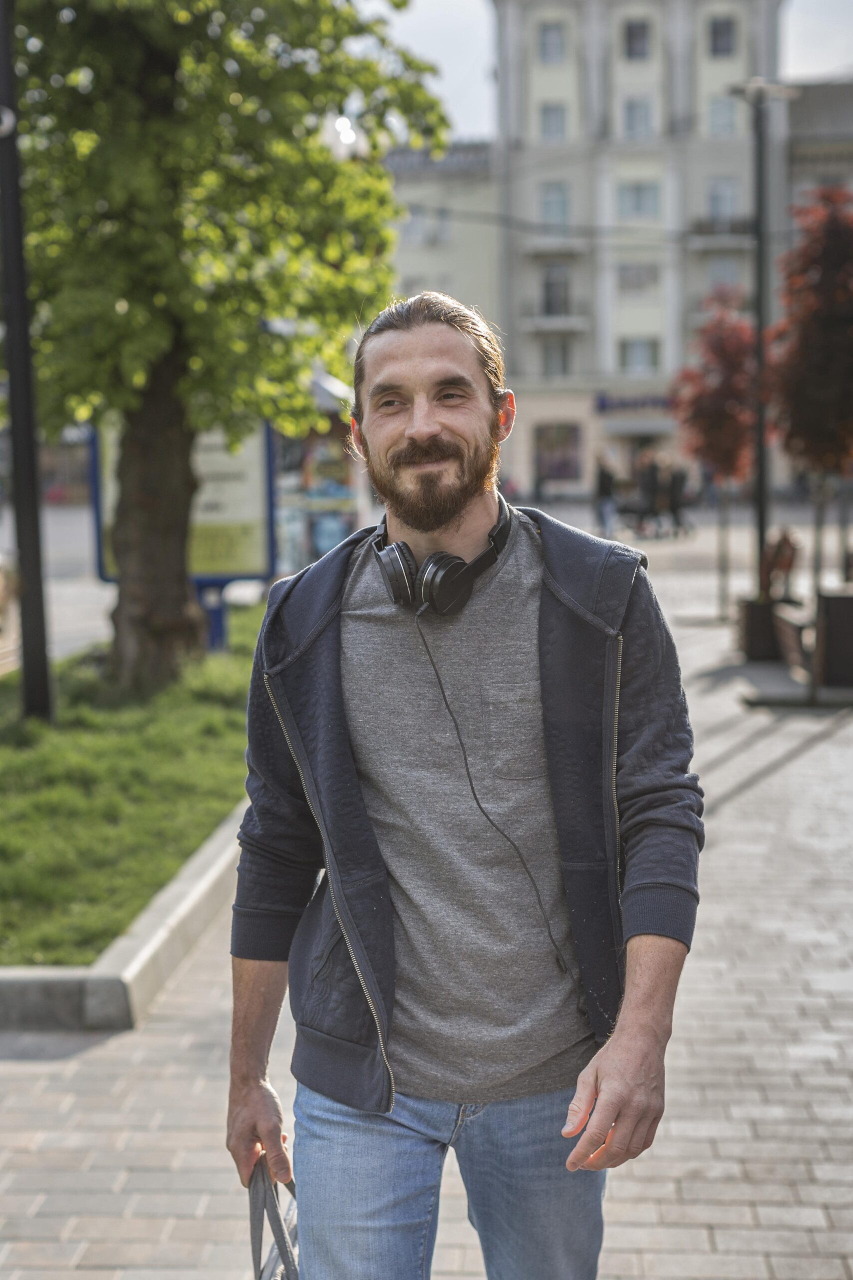 front-view-man-with-headphones-city-min