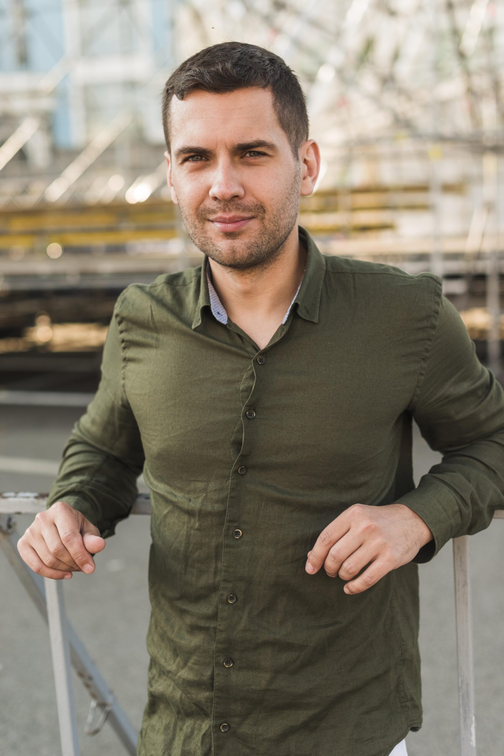 portrait-man-standing-amusement-park-looking-camera-min